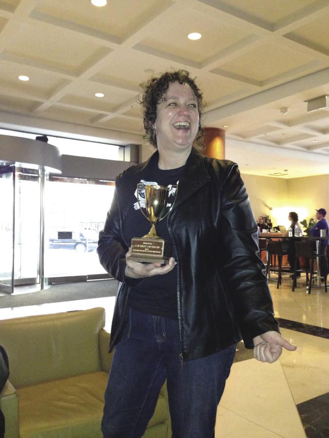 Editor-in-Chief Amy Meyer holds the best of show trophy at the convention in San Francisco March 3. Photo by Jane Martin