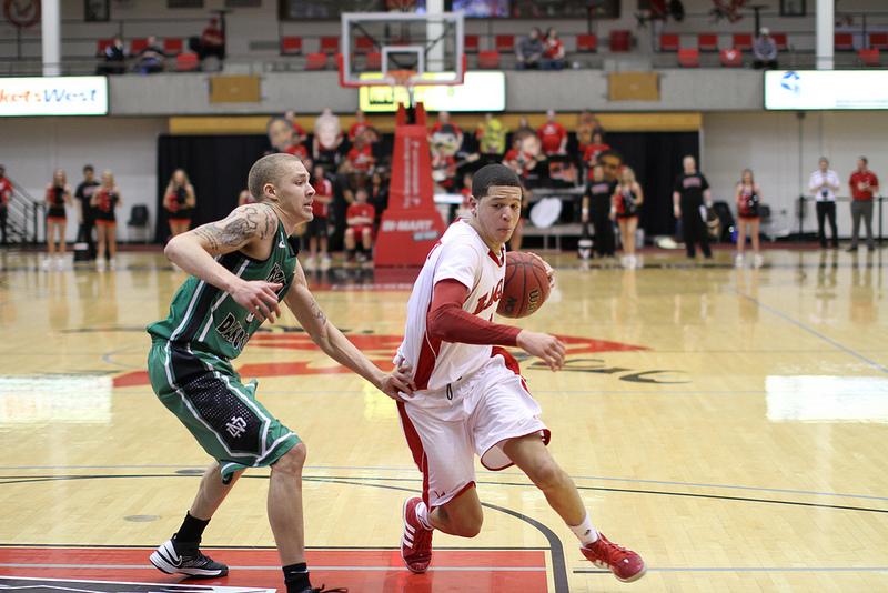 Photo by: Aaron Malmoe

Tyler Harvey drives to the basket against North Dakotas Troy Huff. Harvey led the team with 21 points off 9-of-17 from the floor. He also led the team with eight assists.