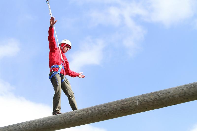 Mike Conrad balances on the wooden beam of the challenge course. The Challenges range from 25-40 feet in the air.