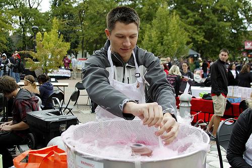 Chris Michaels spins cotton candy for students at Neighbor Festival. 