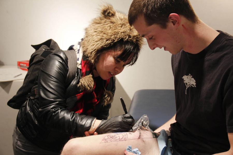 Photo contributed by Jamie Hahn.
As a performance art piece, EWU senior Nicholas Stewart had other students draw on his leg to be later tattooed. 