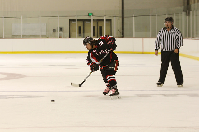 Chase Wharton Sending the puck down the ice.