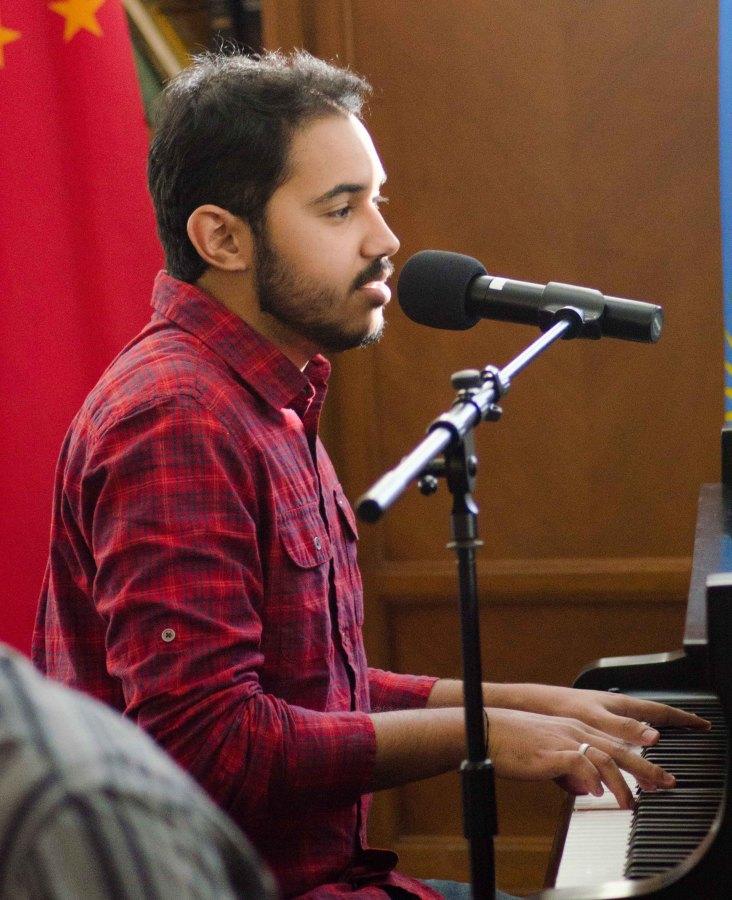 Thiago Souza, EWU student, plays piano and sings at the luncheon.