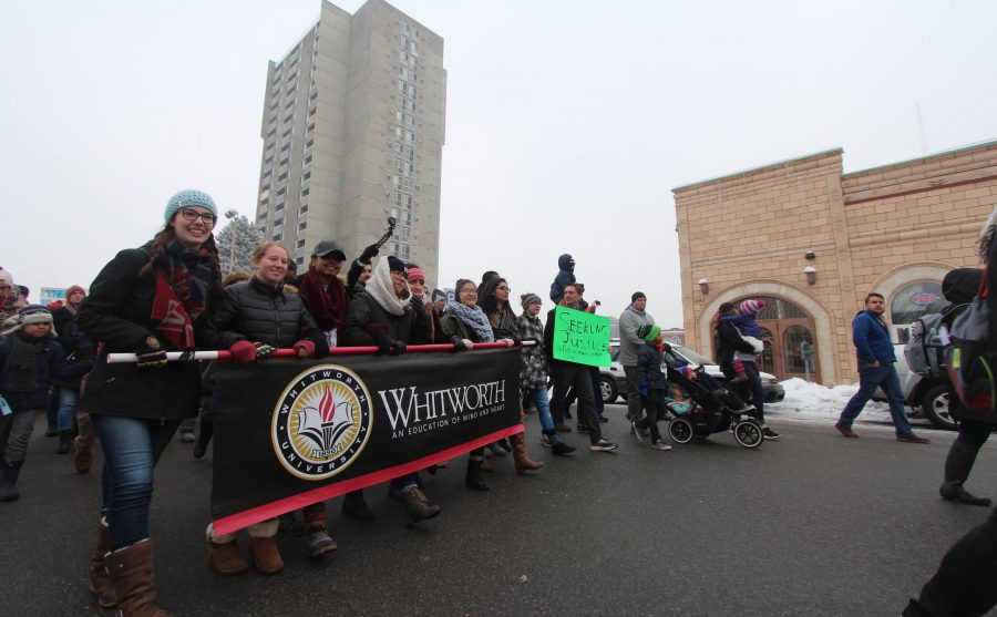 A group of Whitworth students march through the streets of downtown Spokane.