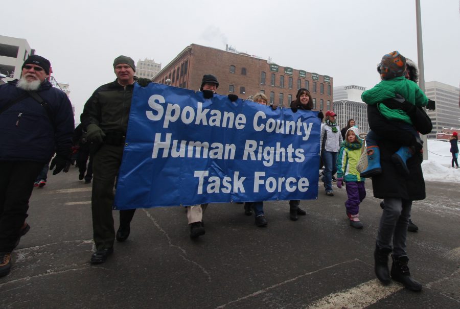 A group of people walk through the streets of downtown Spokane, supporting the Spokane County Human Rights Task Force in the annual MLK Day march.