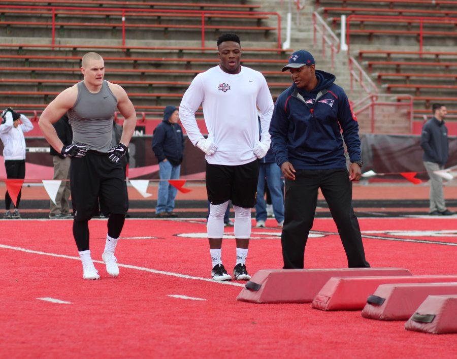 NFL scouts meeting at midfield during EWU's pro day.