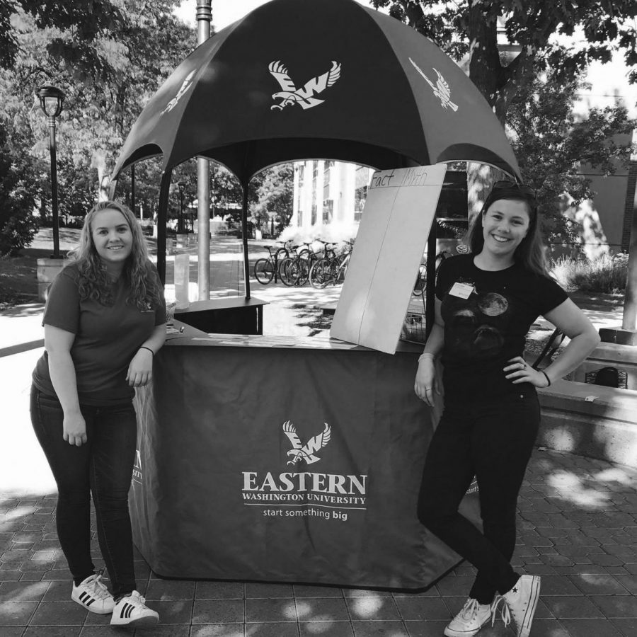 Sophomore Rylie Campbell (left) and Senior Carrie Cutler (right) stand with the Health Hut table at an event earlier this year. The wellness club gives students tips and swag at the hut twice a week | Photo courtesy of the EWU Health and Wellness Facebook page