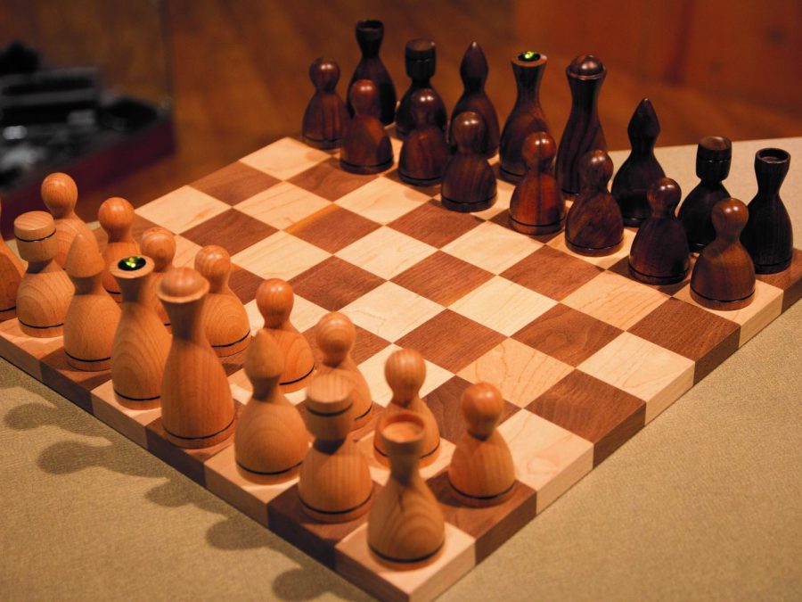 EWU alum Steve Whitfords wooden chess set that he carved. Whitford is now concentrating on creating usable art and small furniture in his wood shop | Photo courtesy of Tori Bailey