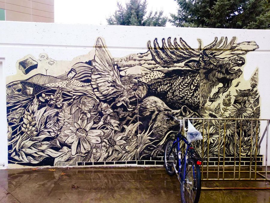 Instructor Reinaldo Gil Zambrano guides students through the printmaking process to design a mural. The mural has been placed at WSU, the University of Idaho and outside of the Computing and Engineering Building at EWU | Photo courtesy of Reinaldo Gil Zambrano 