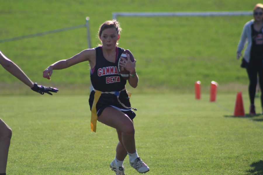 Gamma Phi Beta President Ali Blanton, evades a flag puller. Flag football was one of the highlights of Greek Week | Mckenzie Ford for The Easterner