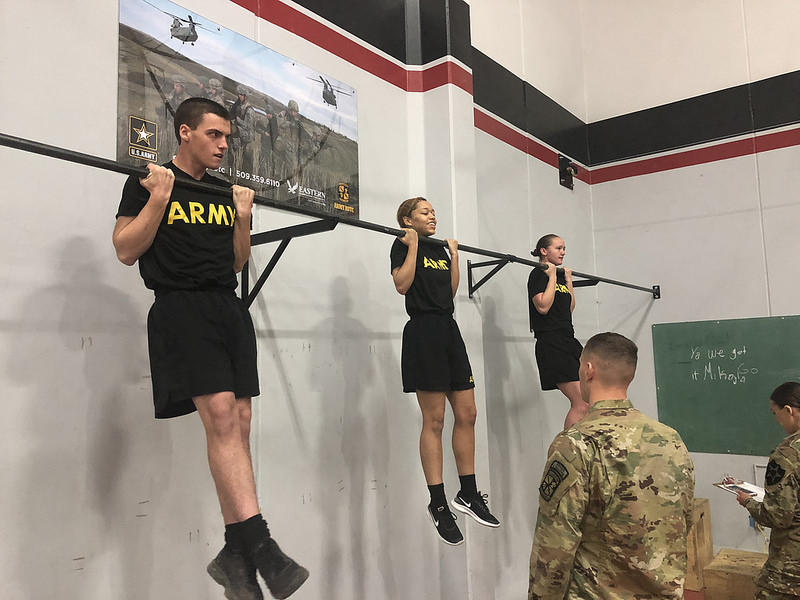 (Left to right) EWU ROTC Cadets Thomas Luce, Amayia Roberts and Megan Anderson compete in the flexed arm hang event. Competitors were required to complete a variety of tests in order to receive the German Armed Forces Proficiency Badge.