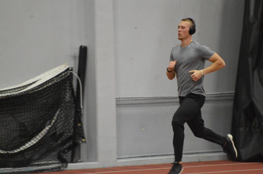 Senior hurdler Parker Bowden runs around the field house track on Jan. 10. Bowden Jr. finished second in the 60-meter hurdles at the Lauren McCuskey Memorial Open on Jan. 12.