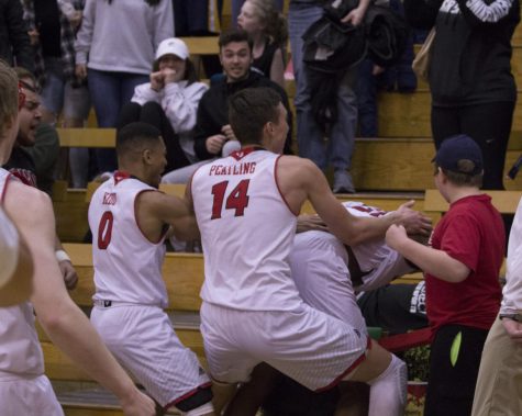 Juniors Mason Peatling and Tyler Kidd swarm freshman Kim Aiken, after Aiken made a buzzer beating 3-pointer to give EWU a 68-66 win on Saturday. Aiken led the Eagles with 19 points in the game.