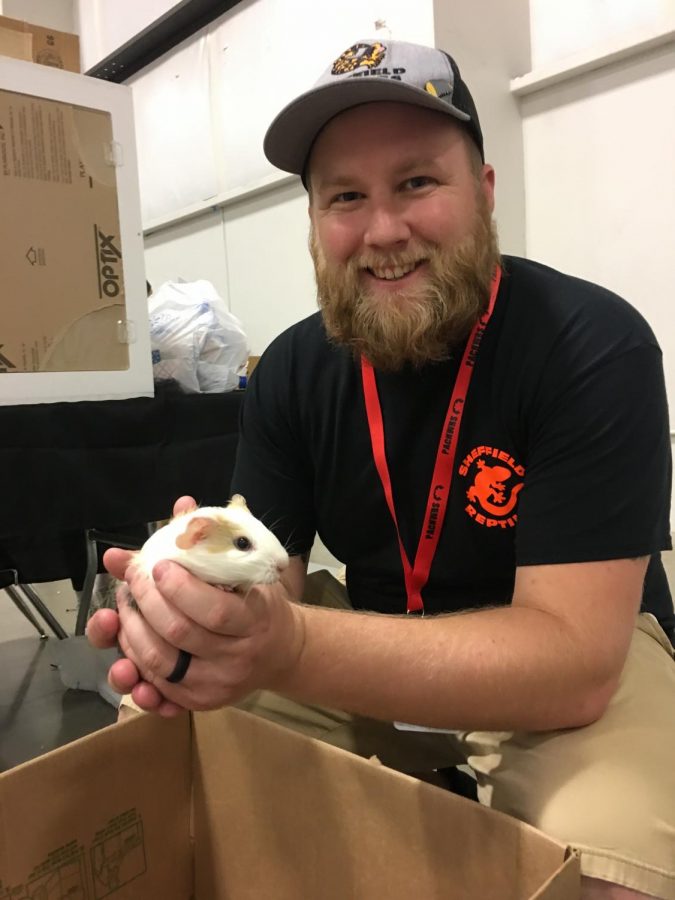 Hunter Sheffield holding a guinea pig for Sheffield Reptiles.