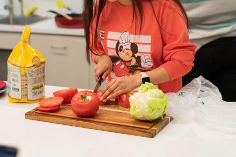 Deseray Vasquez, an EWU MEChA officer, prepares ingredients during a live cooking demonstration Tuesday in the Multicultural Center.