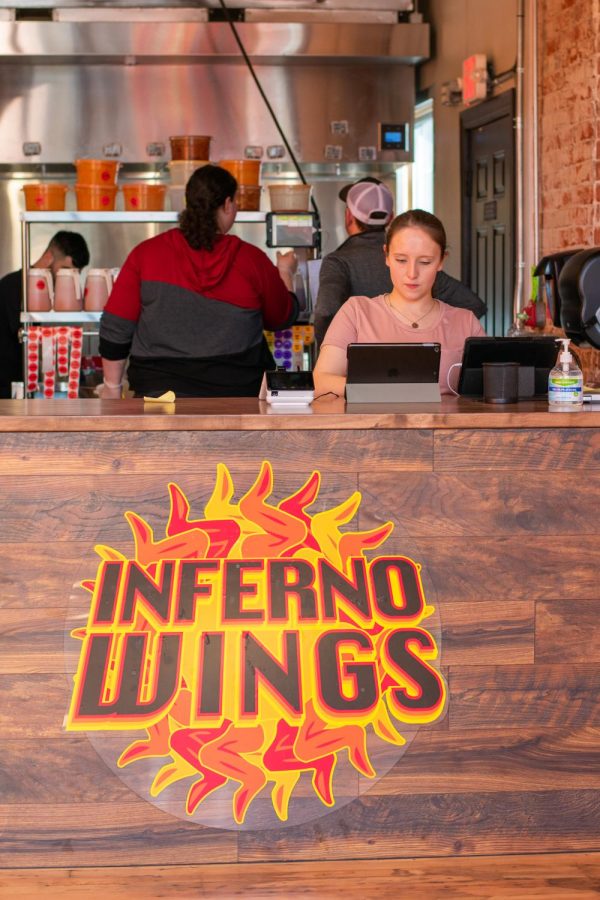 Sabrina Anderson rings in an order opening day at Inferno Wings.