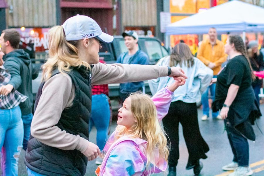 Mother and daughter dances to the music at Mayfest.