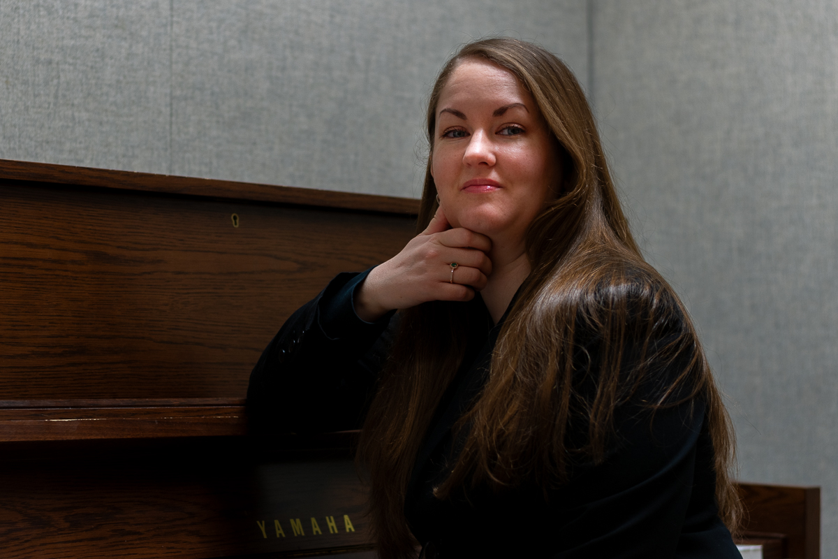  EWU Senior Hilary Baird poses with a piano in one of her favorite rooms to practice in, located in the EWU Music Building