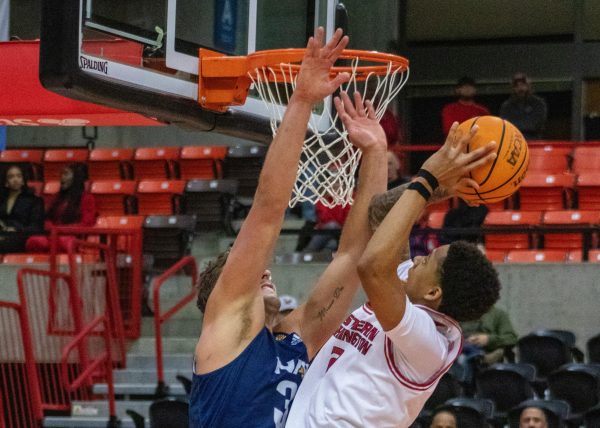 Sophomore guard Mason Williams attempts a layup over a Northern Arizona defender on Jan. 23. Last week, Williams scored the most points in both of EWU’s games.