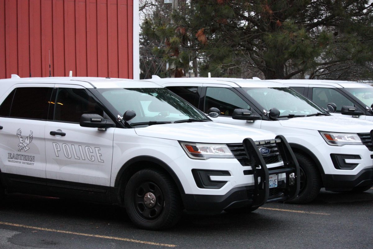 Eastern Washington University Police Department vehicles line up in front of the department headquarters, the Red Barn.