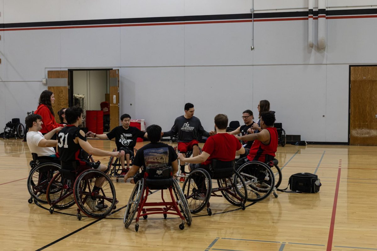 The EWU wheelchair basketball team circles up for a post-practice meeting.