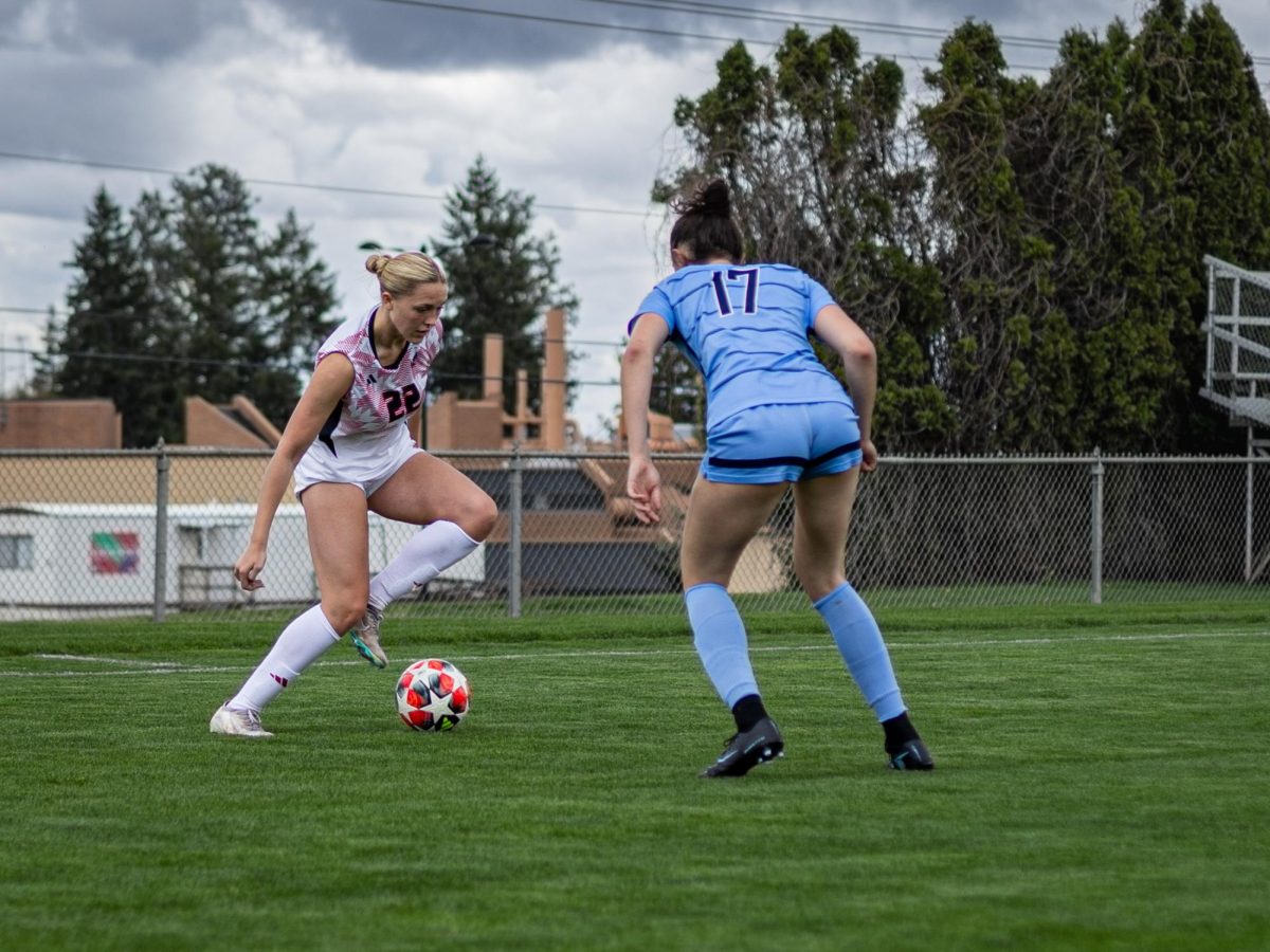 EWU sophomore forward Ava Hinske dribbles the ball while being guarded by SCC freshman defender Izzie Olson.
